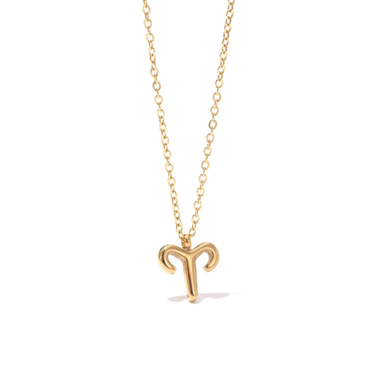 All 12 zodiac symbol bubble necklaces in 18K gold PVD displayed on a stone surface. Bold, chunky glyph pendants on delicate cable chains — waterproof and tarnish-free.